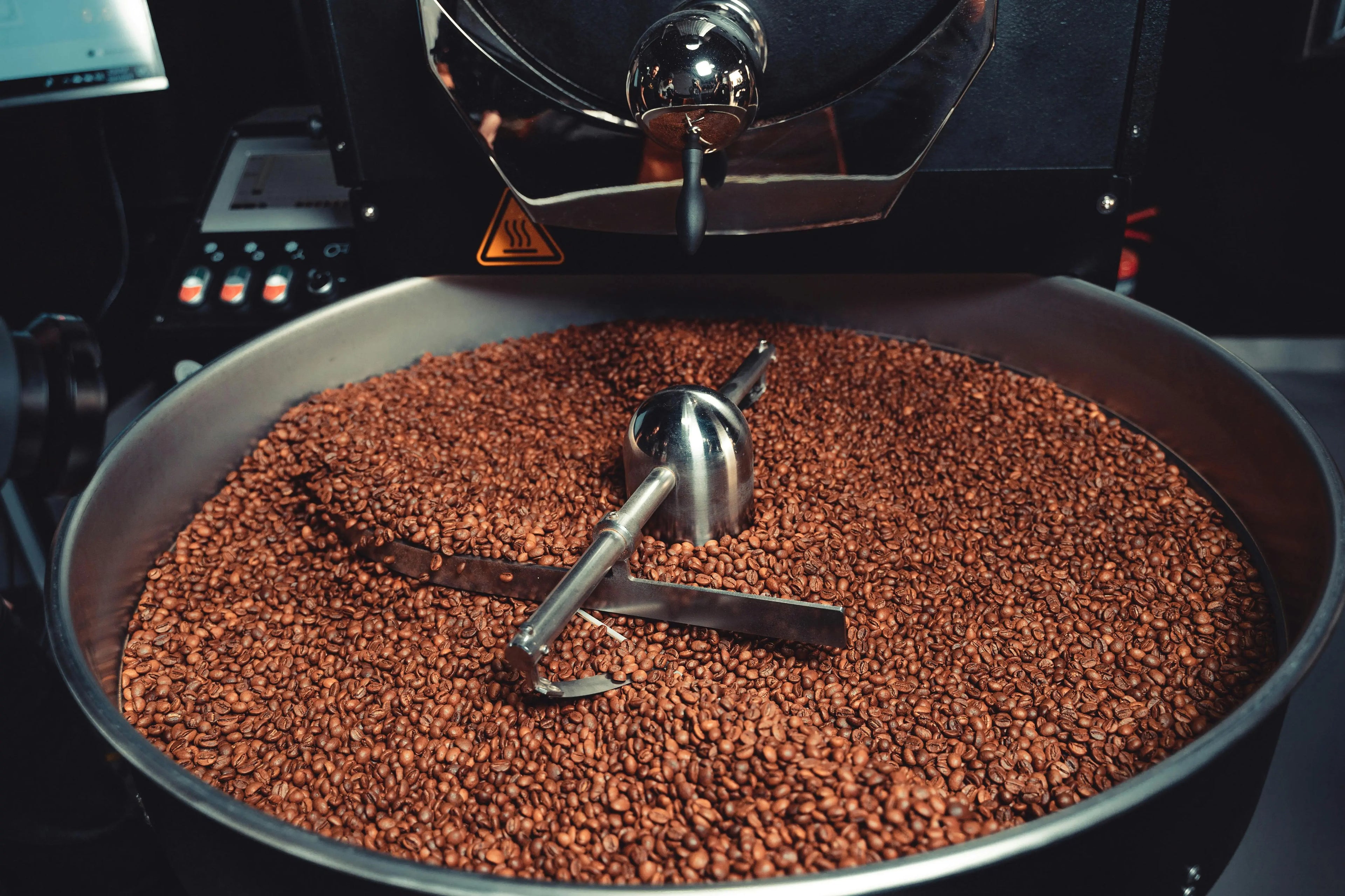 Coffee beans being roasted in a machine with a focus on the roasting process.